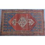 A Persian rug, with a central pearl medallion on a raised ground with multiple borders, 160cm x