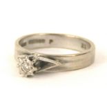 An 18ct white gold solitaire diamond ring, in illusion setting, on a raised ring head, marked to