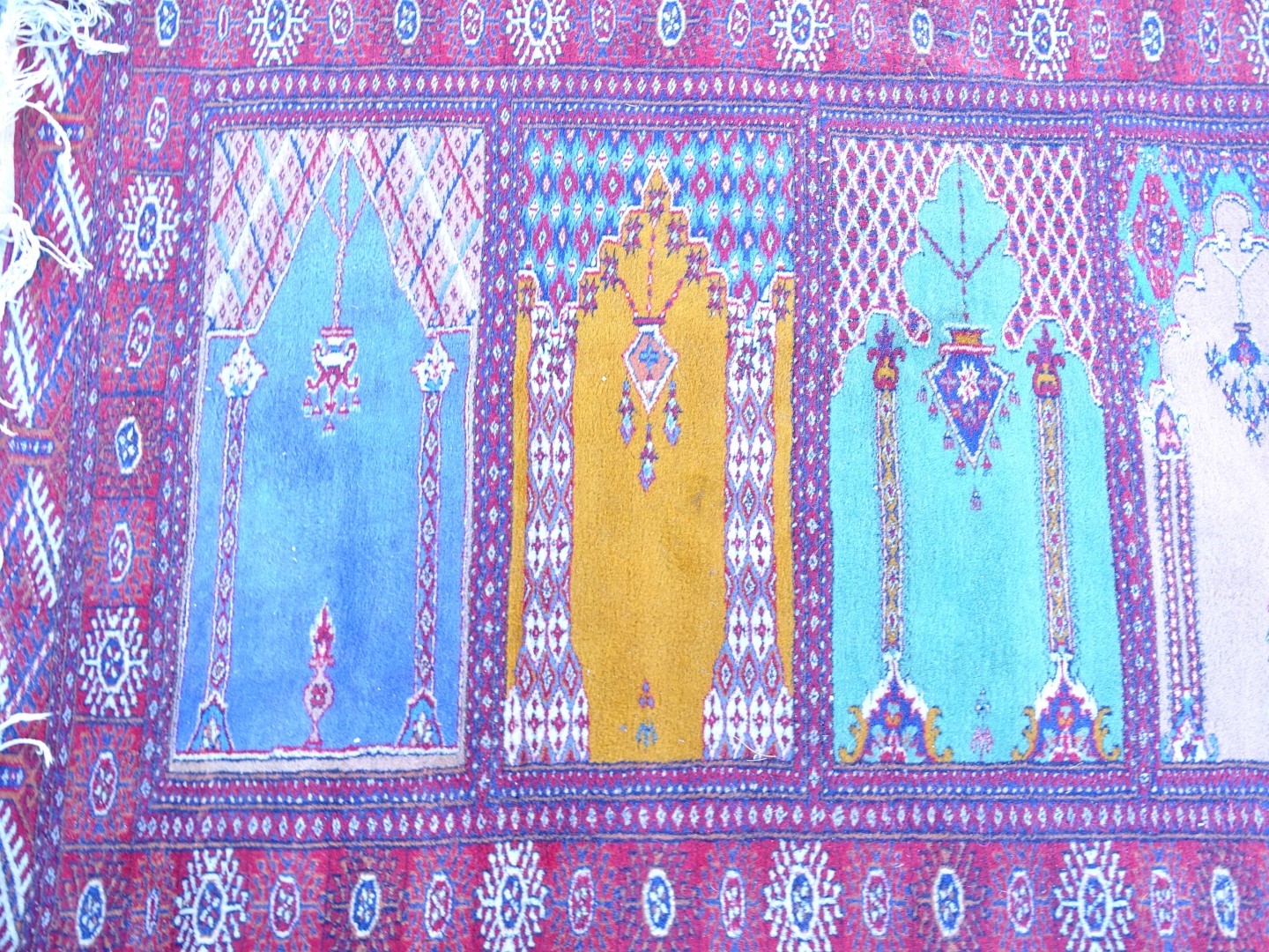 A Persian style multi mihrab prayer rug, with a design of windows, vases, etc. in multiple colours - Image 2 of 3