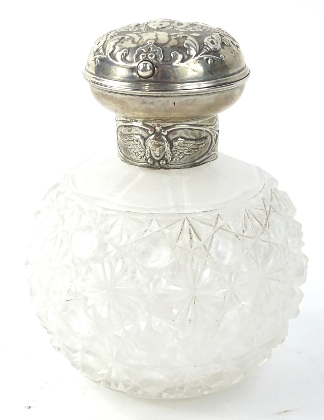 An Edwardian cut glass scent bottle, with hinged silver lid, decorated with angels etc, Birmingham