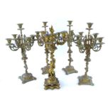 A set of four cast brass candelabra, with cherub bases together with a 19thC French ormolu