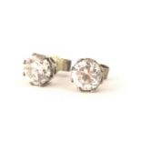A pair of diamond stud earrings, each set with diamond approx 0.5cts, in a claw setting, white metal