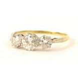 A three stone diamond ring, the central round brilliant cut diamond approx 0.50cts, flanked by two