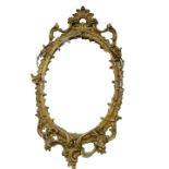 A 19thC gilt gesso oval wall mirror, decorated with flowers and rococo scrolls, etc (AF), 142cm x