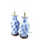 A pair of modern Chinese table lamps, each decorated in blue with carp etc., 51cm H, without