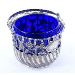 A George III silver swing handle dish, with pierced decoration, inner blue glass liner, London 1773,