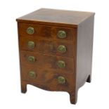 An early 19thC mahogany commode, with a cross banded top above a false drawer and a pull out