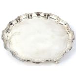 A George V silver salver, with a piecrust border and three scrolling feet, Birmingham 1931, 11½ oz.