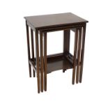 A nest of three Edwardian mahogany tables, each on square tapering legs, the smallest table with