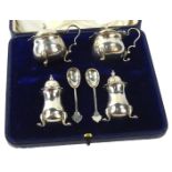 A Edward VII silver four piece cruet, comprising of a pair of mustard pots, each with a blue glass