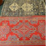 A Turkish rug, with a typical design in red and grey, 196cm x 110cm and a worn Eastern rug with a