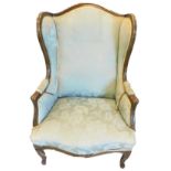 A French mahogany show-frame wing chair, with a padded back, arm rests and seat upholstered in