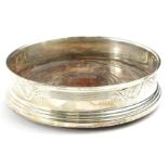 A 20thC silver mounted wine coaster, with wooden base, marks rubbed.