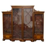 An Edwardian mahogany breakfront bookcase, the central section with a dogtooth inlaid and moulded