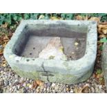 A D shaped hewn stone sink or planter, 55cm W. (AF)