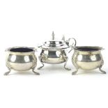 A late Victorian silver three piece cruet, comprising mustard pot, and two open salts, each with a