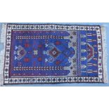 A Persian style rug, with a directional design, on a purple ground with multiple borders, 115cm x