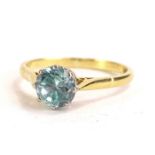 An 18ct gold dress ring, set with single round brilliant cut aquamarine, in platinum claw setting on