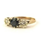 A sapphire and diamond three stone dress ring, set with central round brilliant cut sapphire, in