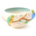 A Clarice Cliff bowl, moulded with parrots on branches, with ribbed sides, printed mark to