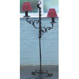 A wrought iron two branch standard lamp, decorated with scroll work, leaves etc., ebonised, 154cm