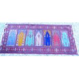 A Persian style multi mihrab prayer rug, with a design of windows, vases, etc. in multiple colours