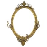 A Victorian oval girandole wall mirror, decorated with wheat ears, flowers, etc., with an