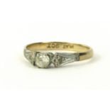 An Art Deco style 9ct gold and platinum dress ring, set with white paste stone, on Art Deco style