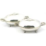 A pair of Danish hammered sterling oval entree dishes and covers in the manner of Georg Jensen, each