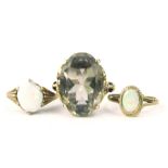 Three 9ct gold dress rings, to include a large smoky quartz set dress ring, and two opal set dress