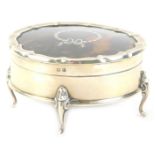 A George V silver tortoise-shell and pique trinket box, with a shaped edge, the hinged lid enclosing