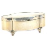 A George V silver trinket box, of lobed form with fabric lined interior, on shaped feet, by