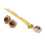 An 18ct gold ruby and diamond pendant and earring set, formed in a floral cluster, with central