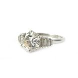 A platinum diamond ring, with round brilliant cut diamond, approx 2cts, in claw setting, flanked