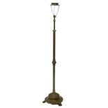 An early 20thC adjustable brass standard lamp, with turned column and circular dome base with claw