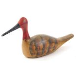 A carved wooden decoy type duck, with a red head and black bill, 36cm L.