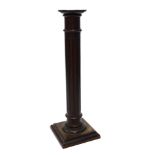 A mahogany torchere, with a plain fluted turned column and a square base, 110cm H.