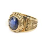 A gentleman's 9ct gold Harvard College ring, with central blue stone emblazoned with stylised eagles