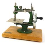 A Grain small sewing machine, with green paintwork, on a wooden base, in original box