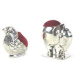 Two silver pin cushions, one in the form of an elephant, the other in the form of a bird. (2)