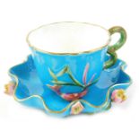 A Victorian turquoise glazed oriental style cup, moulded with fish, shells etc., and a similar