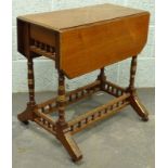 A Victorian walnut aesthetic style drop leaf trolley, with parcel gilt decoration, the rectangular