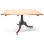 An early 19thC mahogany tilt top breakfast table, the rectangular top with a moulded edge, on a