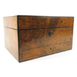 A Victorian walnut dressing case, the hinged lid enclosing a fitted vacant interior, the lock