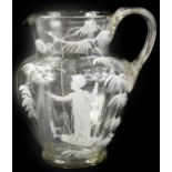 A Victorian clear glass jug, modelled with a boy on a swing in the manner of Mary Gregory, 17cm H.