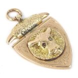 A 9ct gold bull design fob, with shield design, the central circular fob with bull head and gemstone