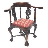 A mahogany corner chair, with two pierced carved splats, a padded seat on cabriole legs with ball