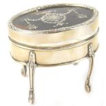 An Edwardian silver, tortoise-shell and pique oval trinket box, the hinged lid enclosing a fitted