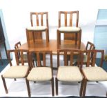 A Danish Dyrlund teak dining room suite, comprising extending dining table, with two loose leaves on