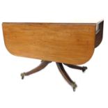 An early 19thC mahogany Pembroke table, with a rectangular top with rounded corners above a frieze